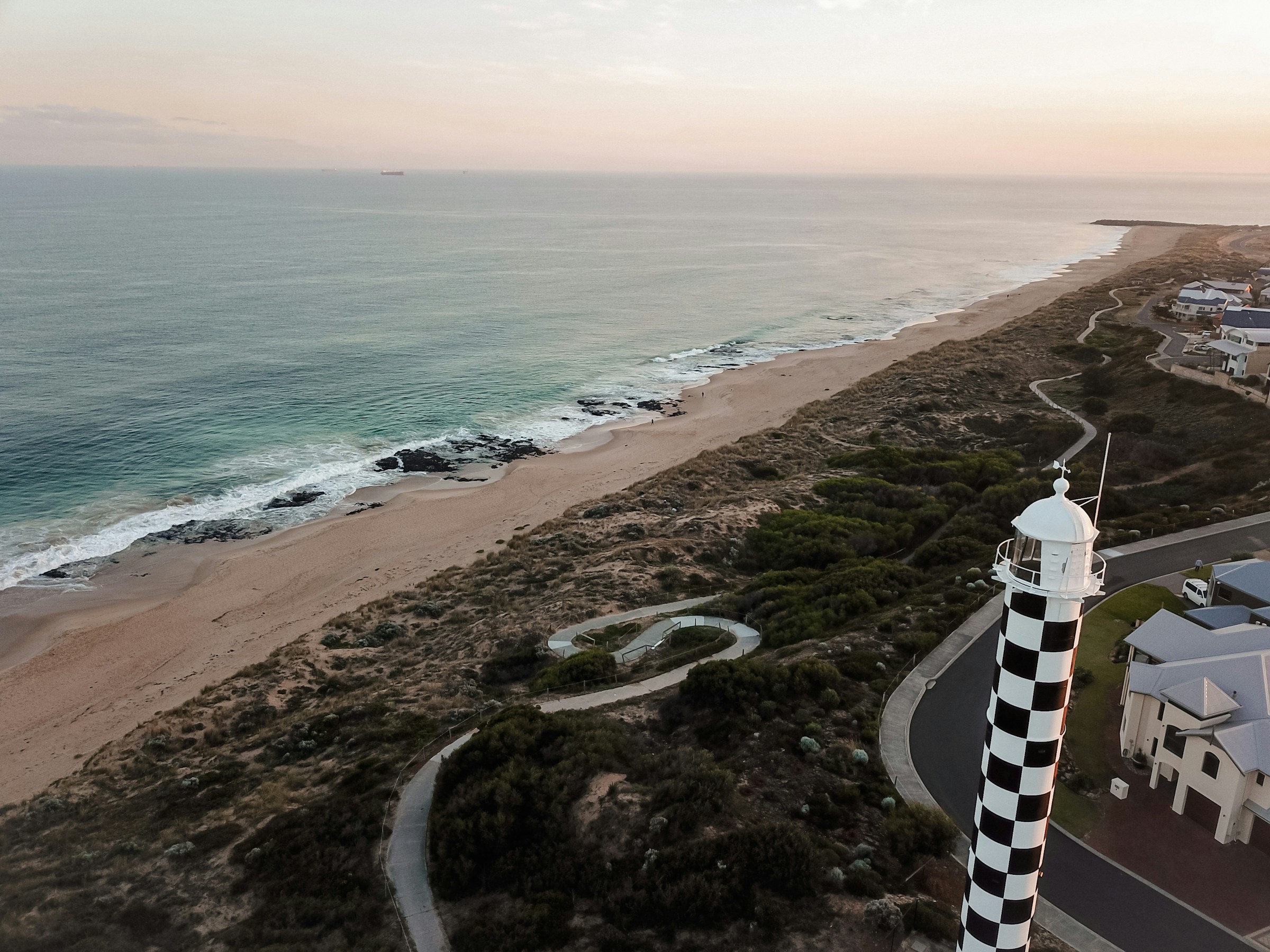 Bunbury's checkered lighthouse over the back beach at dusk — Bunbury's home market