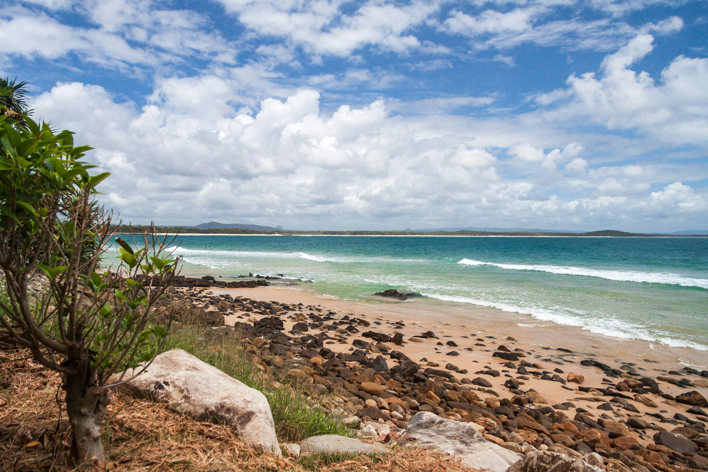 A rocky Coral Sea beach near Mackay — Mackay's home market